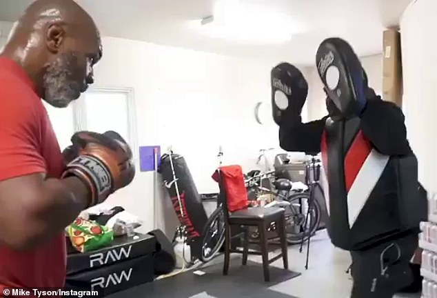 This image has an empty alt attribute; its file name is 28015668-8292633-The_heavyweight_icon_recently_wowed_boxing_fans_after_engaging_i-a-7_1588774825147.jpg